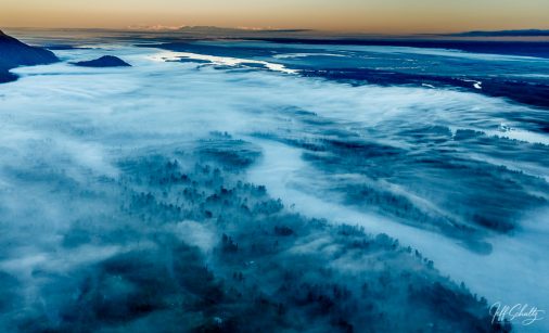 Summer landscape aerial view of fog over Knik River at sunrise Southcentral, Alaska.